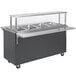 A Vollrath stainless steel portable hot food station with cafeteria breath guard and three compartments on wheels.