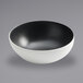 A white bowl with a black speckled rim.