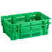 A green plastic agricultural crate with holes.