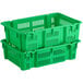 Two green plastic vented agricultural crates stacked on top of each other.