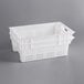 A white plastic agricultural crate with vented sides.