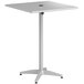 A Lancaster Table & Seating silver aluminum bar height table with a metal base.
