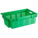 A green plastic agricultural crate with holes.