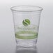 A Fabri-Kal Greenware clear plastic cup with a green logo.