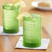 Two Fortessa fern green beverage glasses with lemons on them.