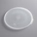 A translucent plastic lid with a circular pattern and a handle.
