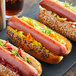 A group of Broadleaf Wagyu Beef hot dogs with vegetables and a drink on a table.