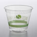 A clear plastic Fabri-Kal cold cup with a green Greenware logo.
