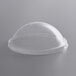 A clear plastic dome lid on a round surface.