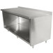 A stainless steel Advance Tabco work table with cabinet base.