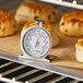 An AvaTemp dial oven thermometer in a baking pan.