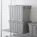 A stack of grey Choice large stackable chafer storage containers.