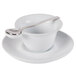 A white CAC porcelain cup and saucer with a spoon in it.