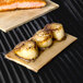 Cedar wood grilling planks with salmon and scallops on them.
