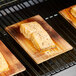 A piece of cooked salmon on a cedar wood grilling plank.