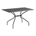 A black Lancaster Table & Seating rectangular outdoor table with metal legs.