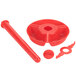 A red plastic object with a round hole and a round cap.
