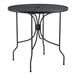 A Lancaster Table & Seating Harbor black wrought iron table with a round top.