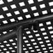 A close up of the metal structure of a black Lancaster Table & Seating outdoor table with ornate legs.