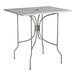 A Lancaster Table & Seating rectangular metal table with ornate legs on an outdoor patio.