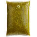 A plastic bag of green sauce with a white label.