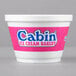 A white Dart foam food container with a pink and blue label.