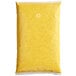 A yellow plastic bag with red speckled substance.