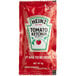 A red Heinz ketchup packet with white text and a white label.