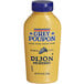 A close up of a yellow Grey Poupon Dijon Mustard squeeze bottle with a blue label.