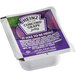 A white Heinz container of grape jelly with purple and green labels.