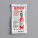 A white TABASCO portion packet with a red and white label.