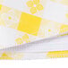 A close-up of a yellow and white gingham vinyl table cover.