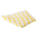 A folded yellow and white checkered vinyl table cover.