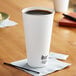 A white Dart ThermoGuard paper hot cup on a table.