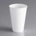 A Dart ThermoGuard white paper hot cup on a gray surface.