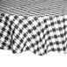 A black and white checkered Intedge vinyl table cover on a table.