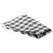 A folded black and white checkered vinyl table cover with flannel back.