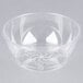 A close-up of a clear Fineline Savvi Serve plastic bowl with a design on it.
