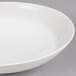A white Reserve by Libbey Royal Rideau coupe bowl with a thin rim on a gray surface.
