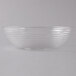 A clear Camwear round ribbed bowl on a white surface.