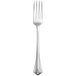 A stainless steel dinner fork with a white handle.