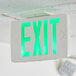 A Lavex green LED exit sign on a ceiling.