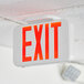 A white Lavex LED exit sign with red text and adjustable arrows.