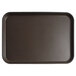 A rectangular tan Cambro non-skid serving tray with a black border.
