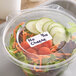 A salad in a plastic container with a Noble Products blank label.