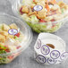 A salad in a plastic container with a purple Point Plus gluten allergen label.