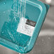 A plastic container with Noble Products Sunday food labeling stickers dissolving in water.