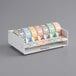 A Noble Products paper label roll dispenser with colorful labels in it.