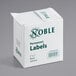 A roll of 500 Noble permanent blank labels with a white box and green text.