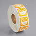 A roll of paper with white and orange stickers, each with white and yellow text reading "Tuesday" and "Day" in orange.